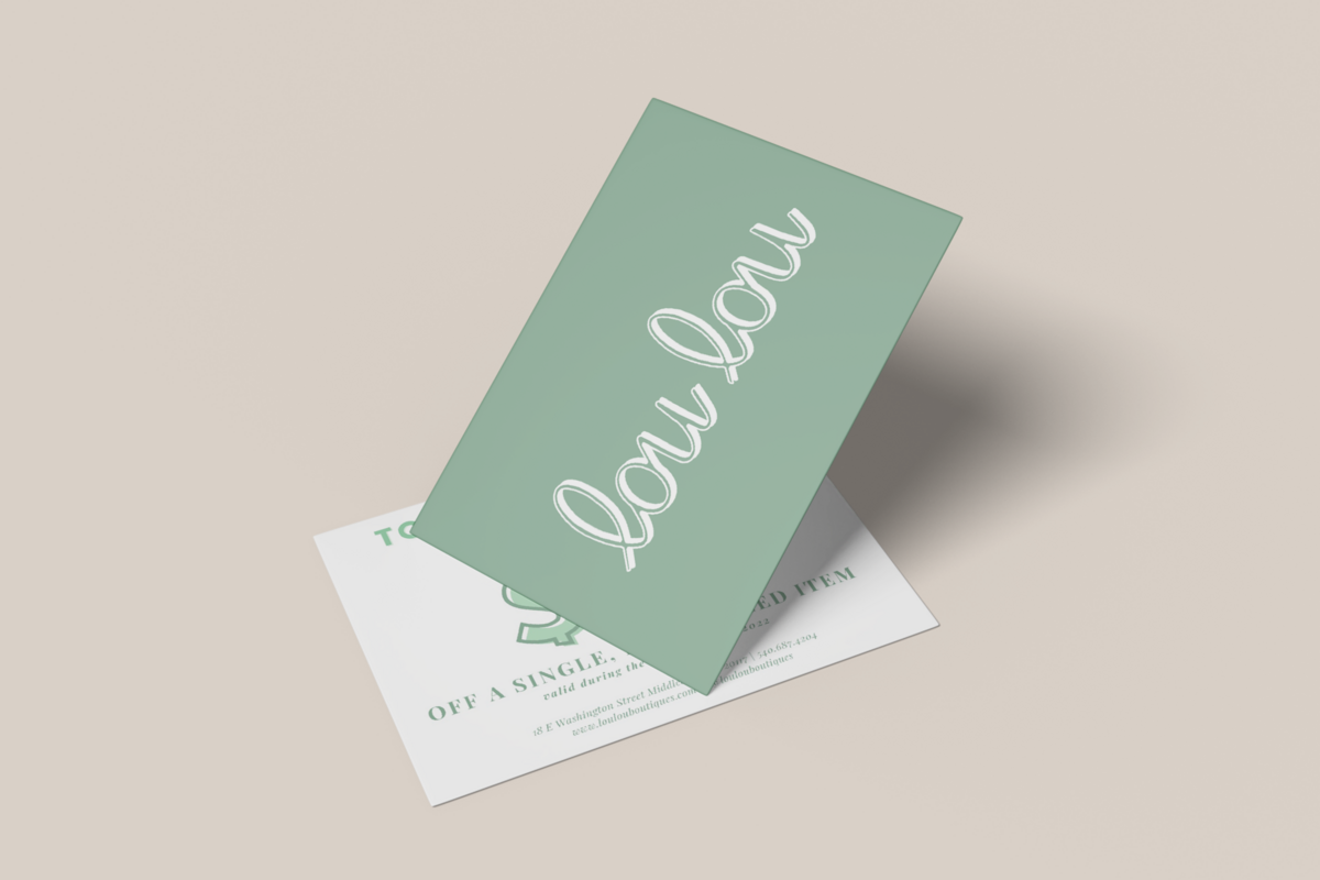 Two overlaying cards, one pale green with cursive text reading "lou lou," the other white, partially hidden with text and a circular design. Both cards are on a neutral surface, showcasing Sweet Pea Ink Creative's expertise in brand identity and web design.