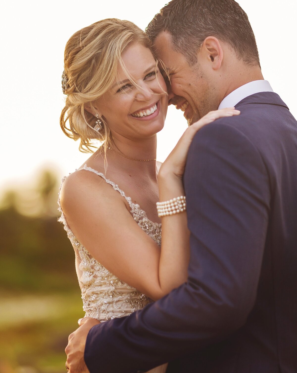 Bride laughing with groom at wedding in Cancun