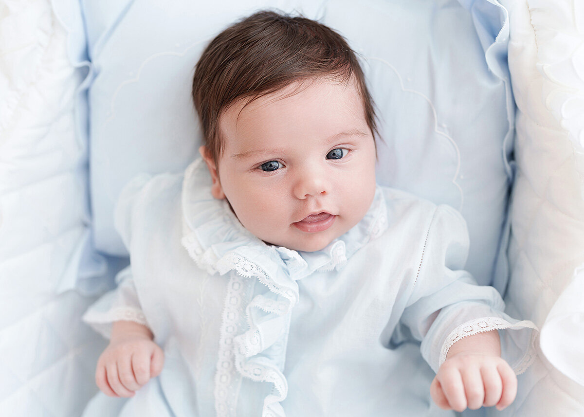 newborn baby boy photographed grandmillenial style in his father's baby outfit