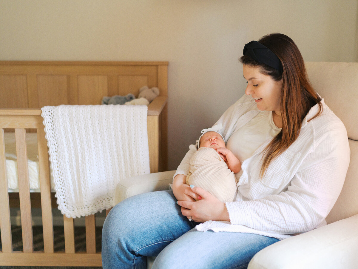 mother-holding-newborn-baby-nursery