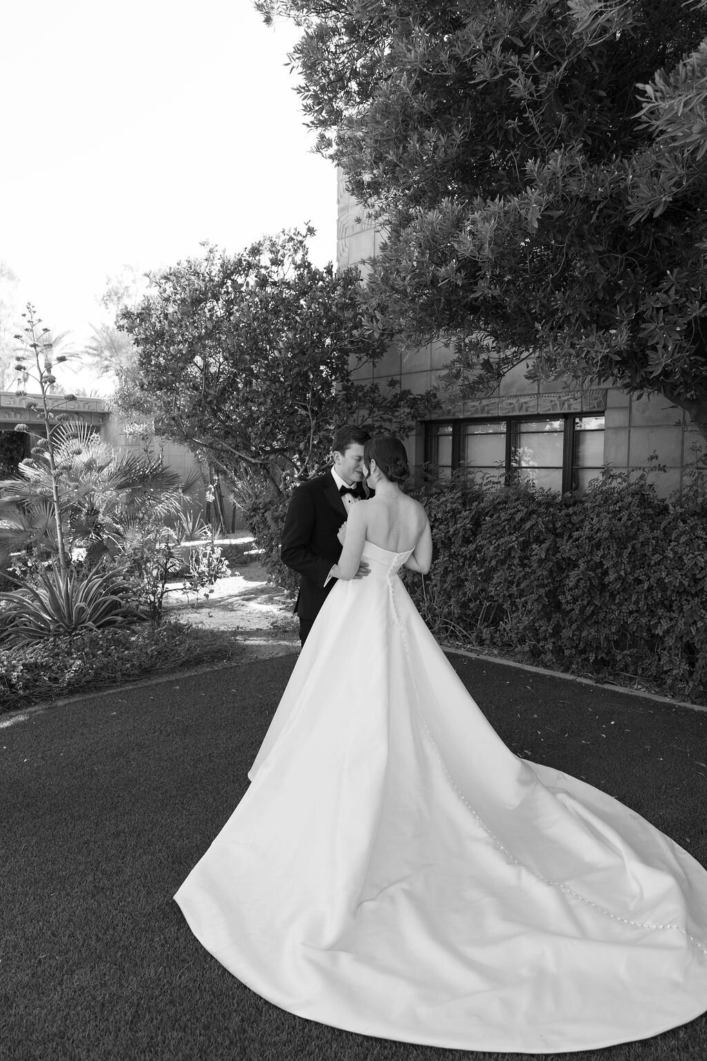 Black and white candid kiss of bride and groom during Arizona Biltmore wedding