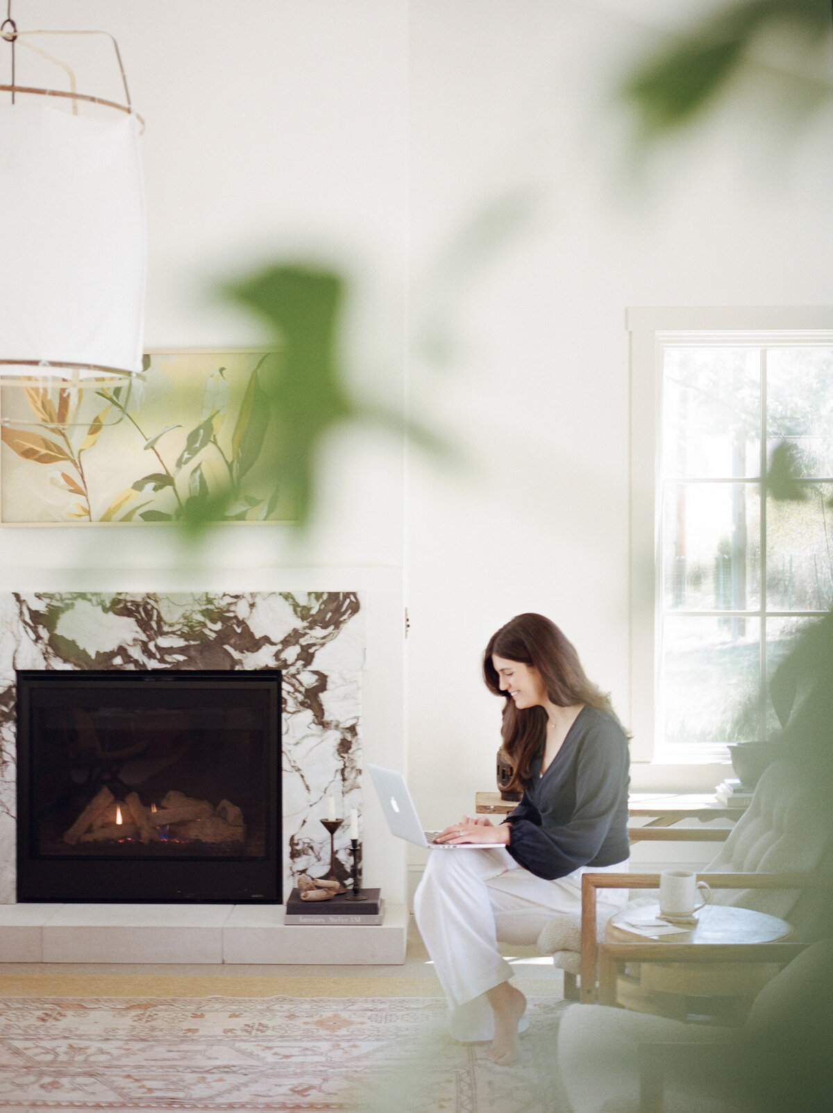 relaxed designer works with laptop in beautiful interior, living room of Fernhaus, Northern Michigan