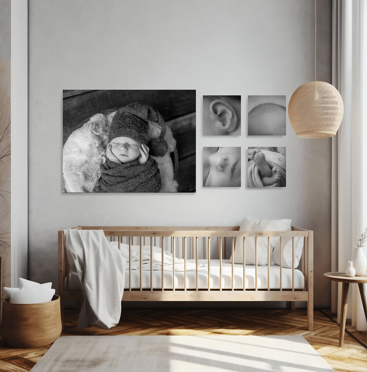 A few newborn fine art portrait prints hang above a bed