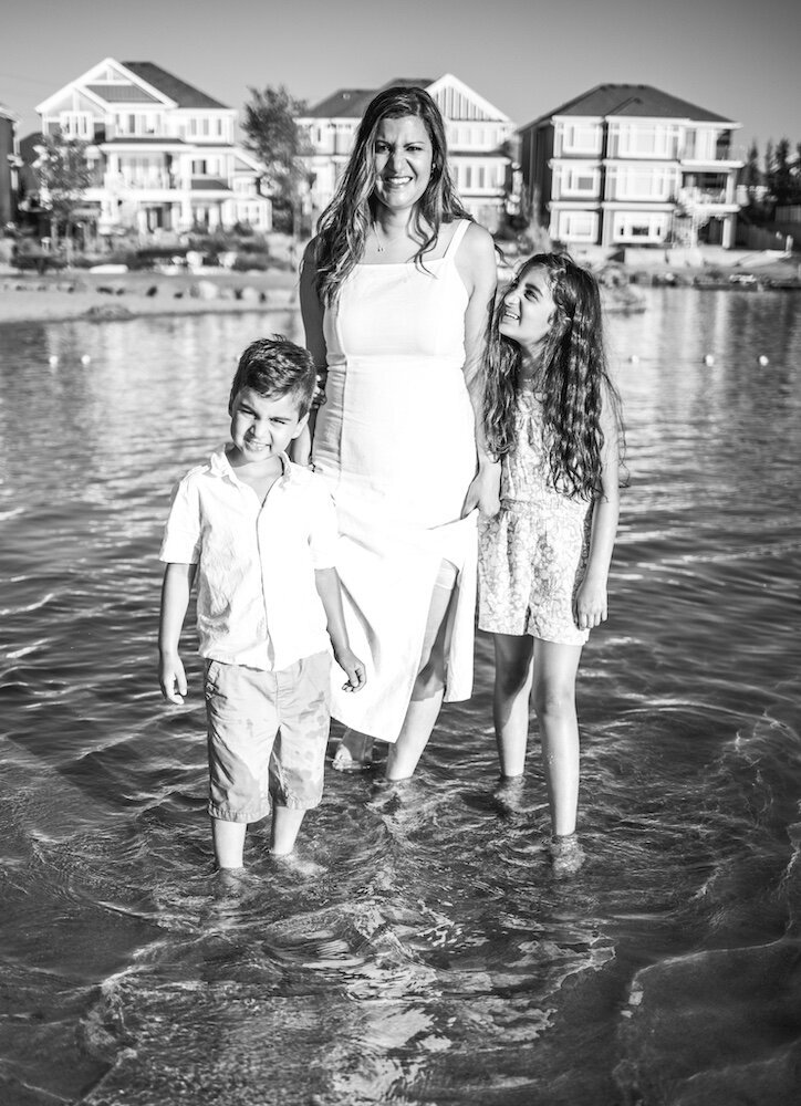 Mother with her son and daughter standing in a lake