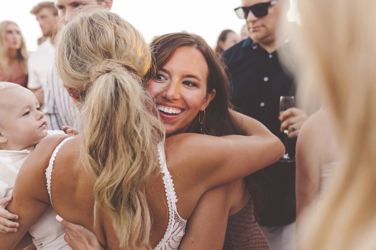 Bride hugging guest at viceroy riviera maya wedding