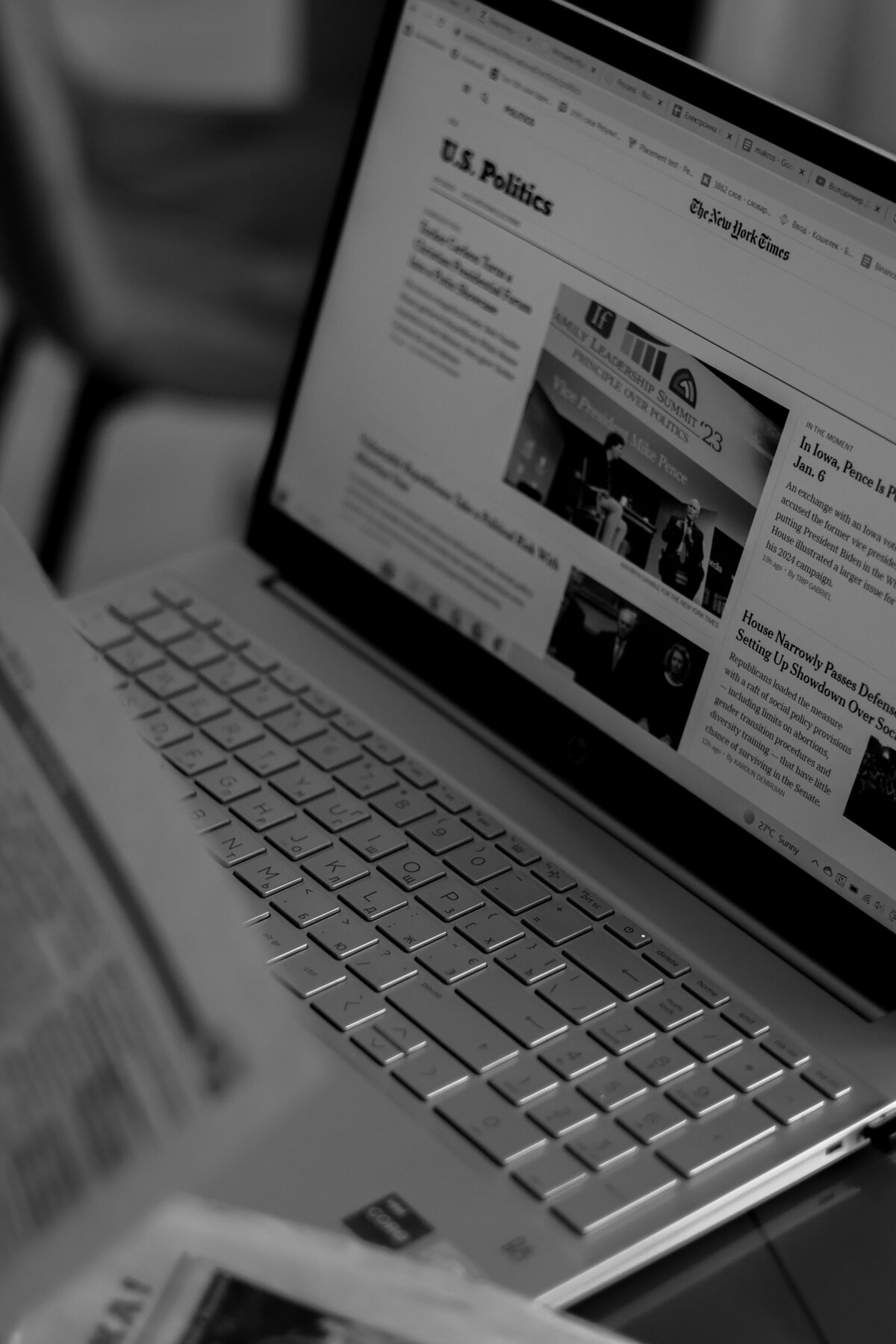 Zoomed in photo of a laptop with news website up and blurred