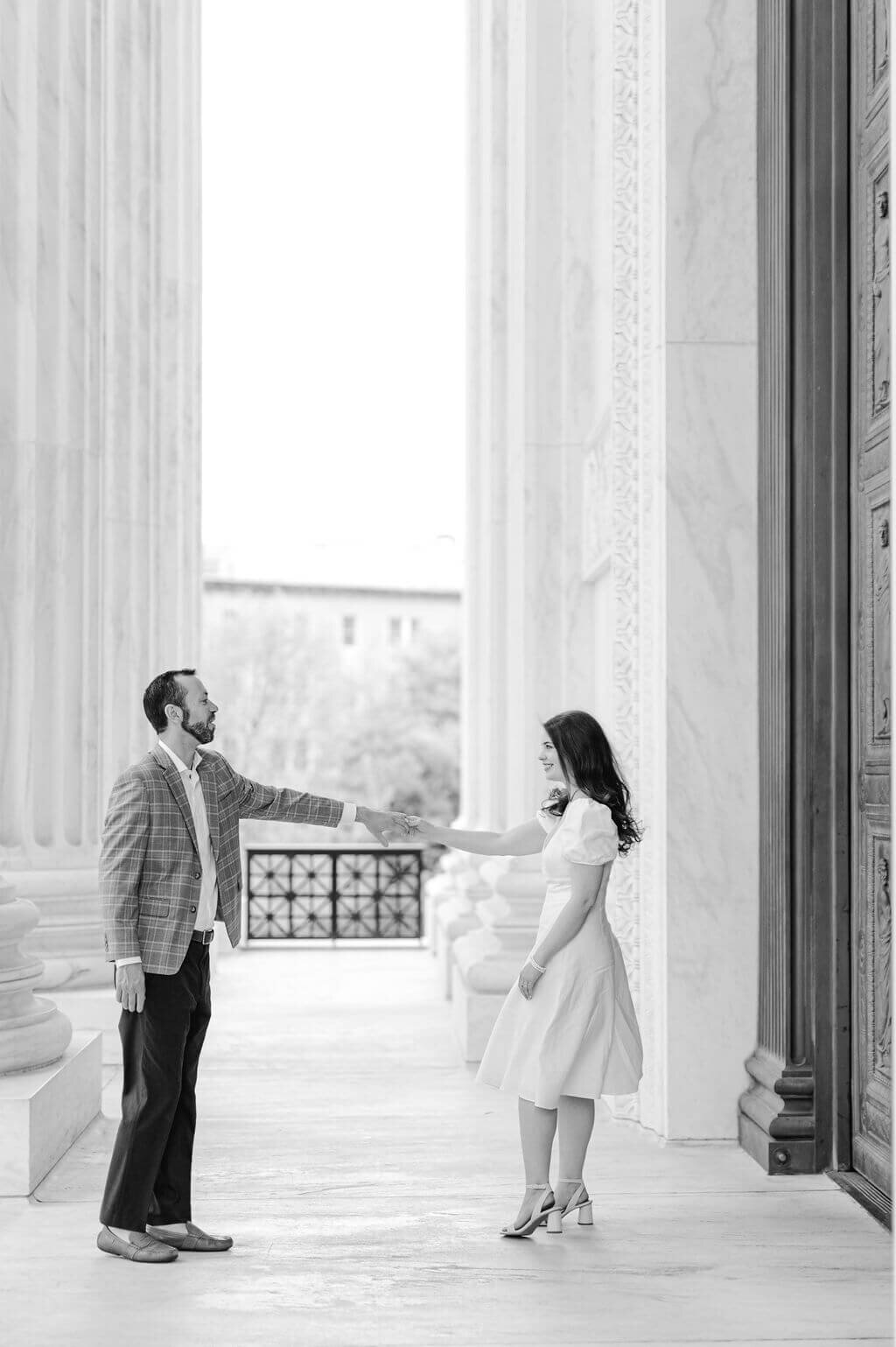 Black and white photo of couple dancing with each other during wedding engagement photos