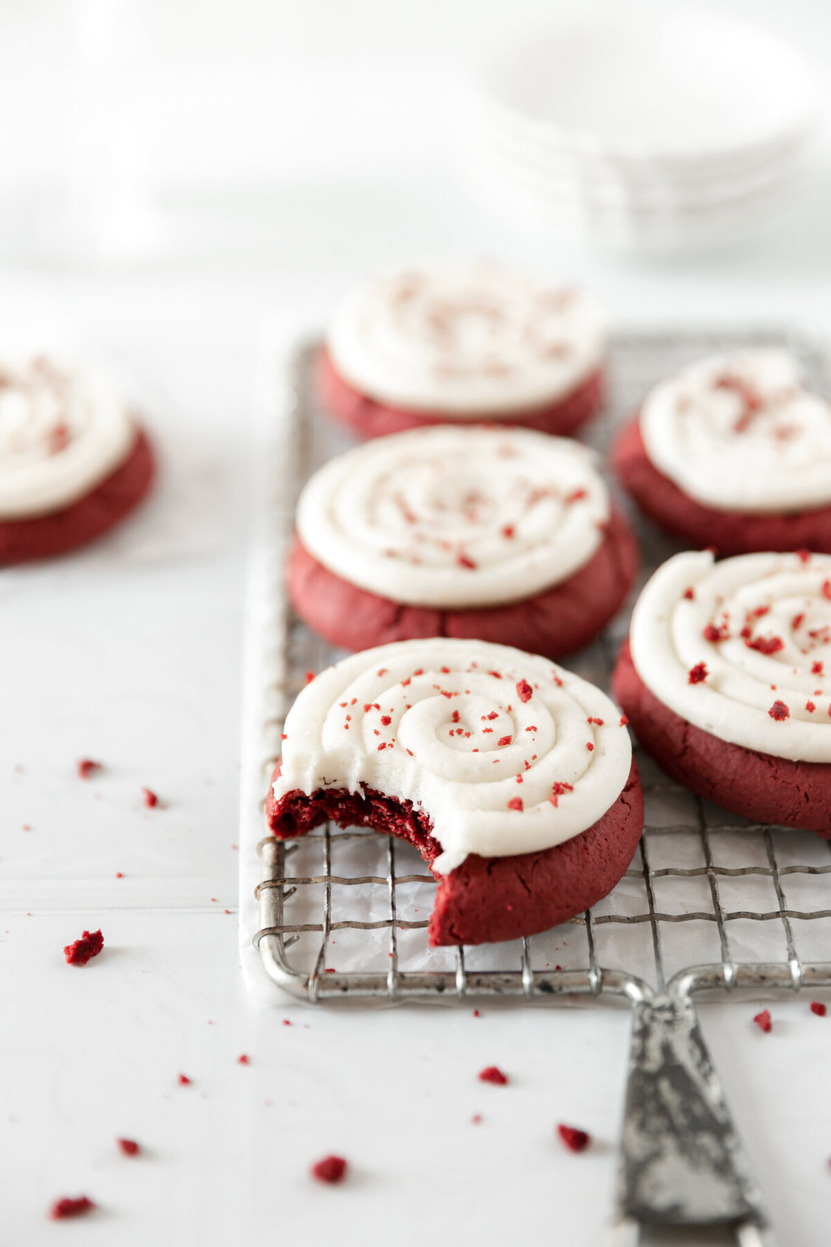red velvet cookies with cream cheese frosting on a cooling rack
