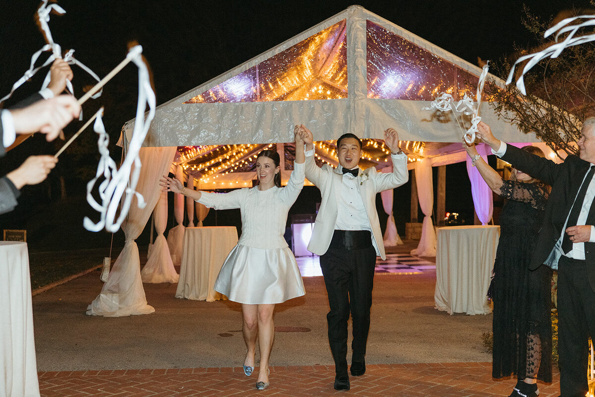 Guests waive white streamers as the couple exits their wedding reception in New York City.