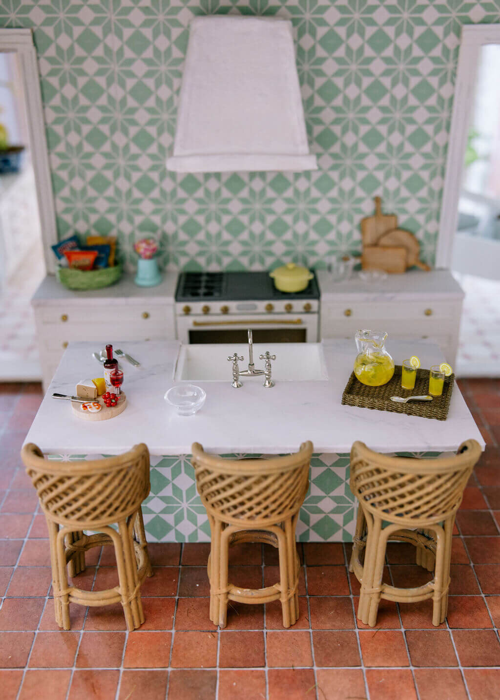 oyster creek studios petite palm beach dollhouse wicker stools in kitchen with white counters and wallpaper