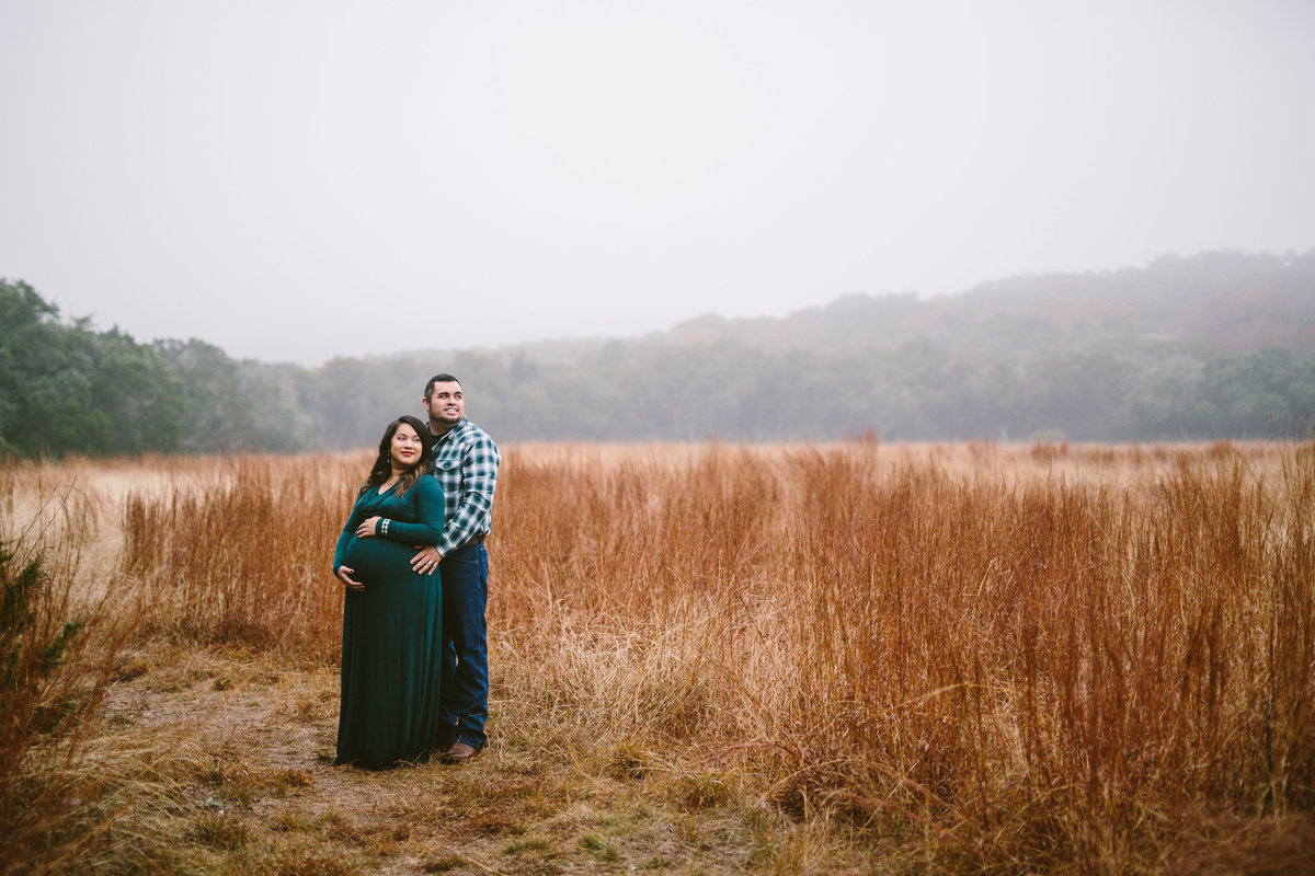 Maternity session of couple in field in the Texas hill country.