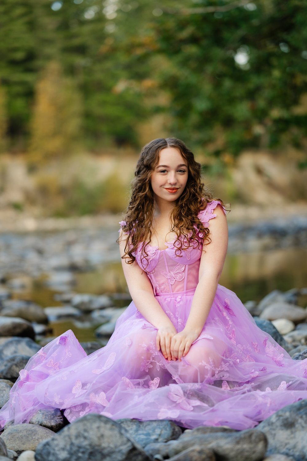 auburn high school senior in pink ballgown at river