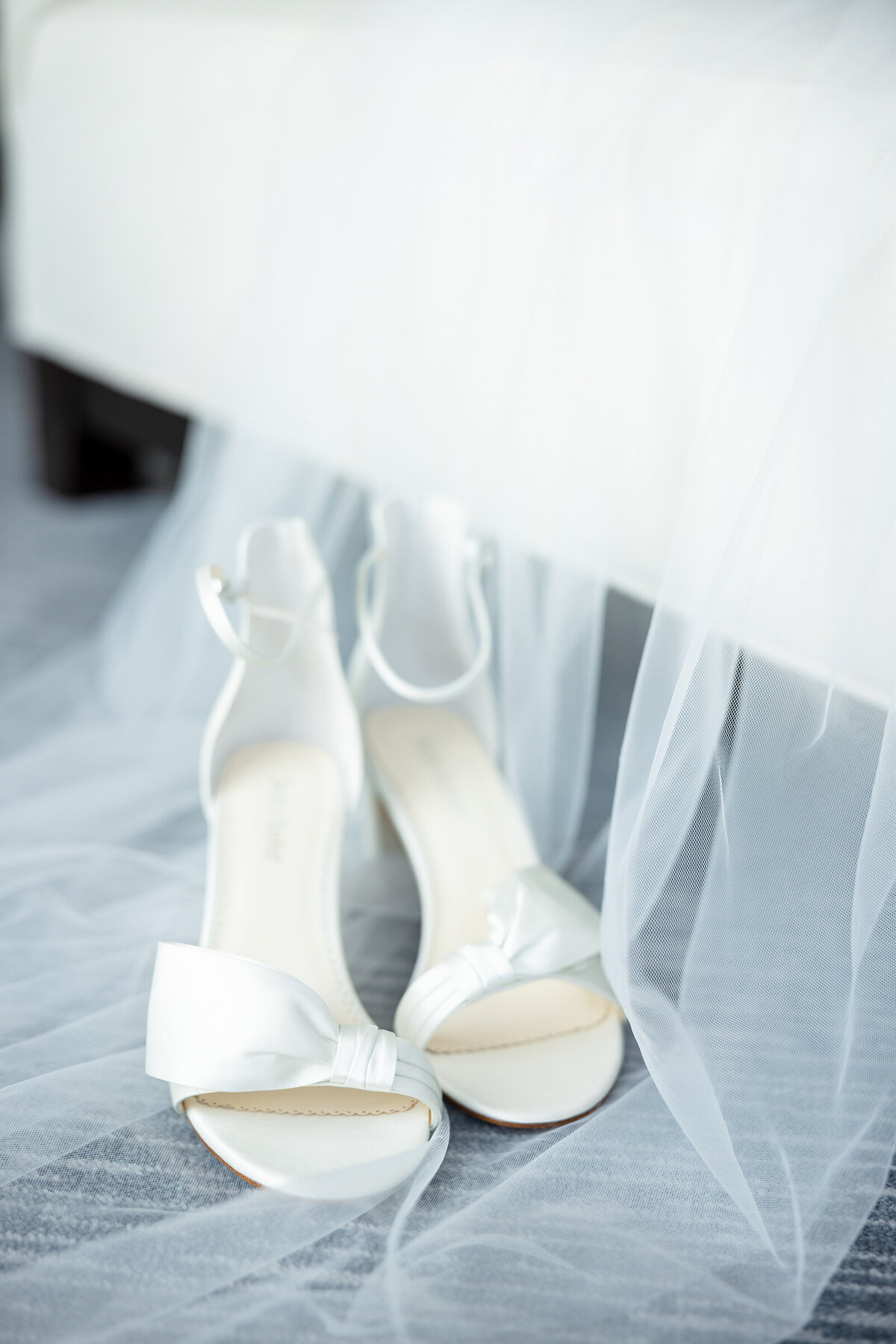 Simple image of Bella Belle wedding sandals on top of the veil