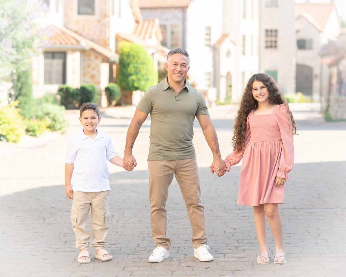 dad, daughter and son in nice colored clothes in Adriatica Village McKinney Texas captured by Allison Amores Photography