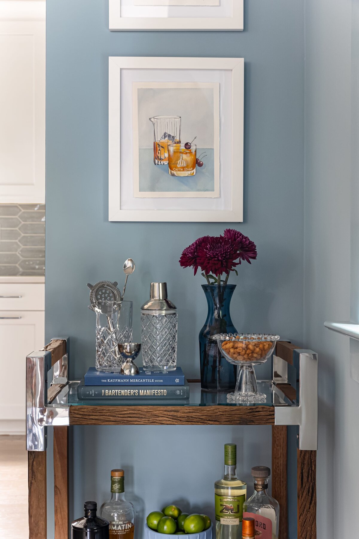 melinda chesson interiors everett place bar cart with painted blue walls and white framed art piece