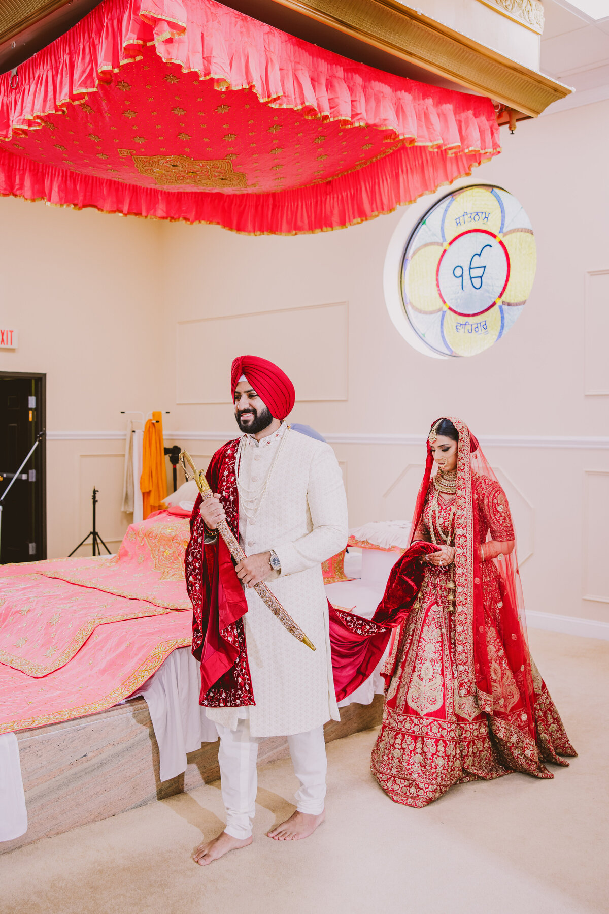A sikh groom smiling while walking around during the anand karaj wedding ceremony at the bridgewater gurudwara in nj