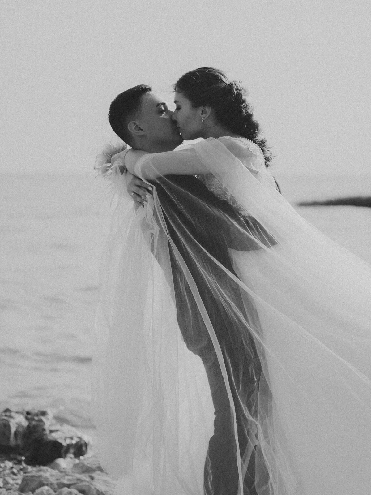 A beach wedding couple kissing each other