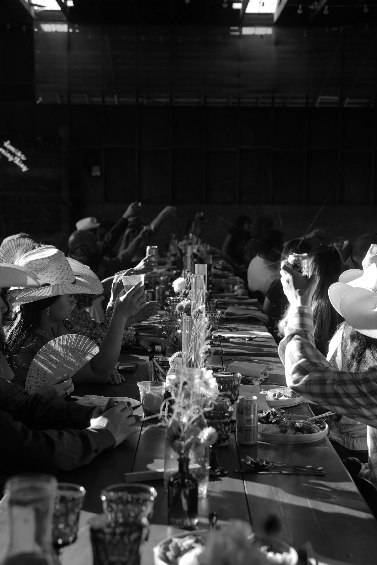 Guests Raising Drinks at Barn Reception | Candid Ranch-Style Oregon Wedding Photography