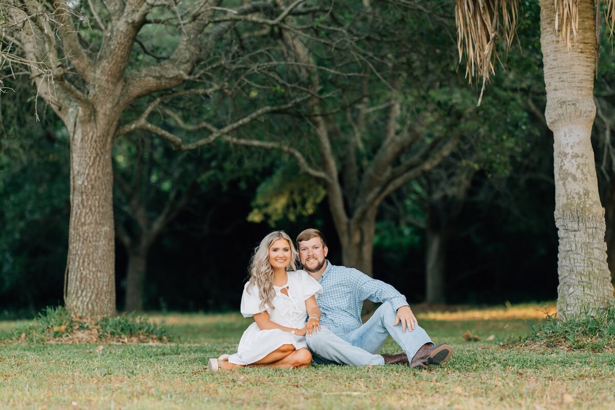 a couple sitting together in a grassy area