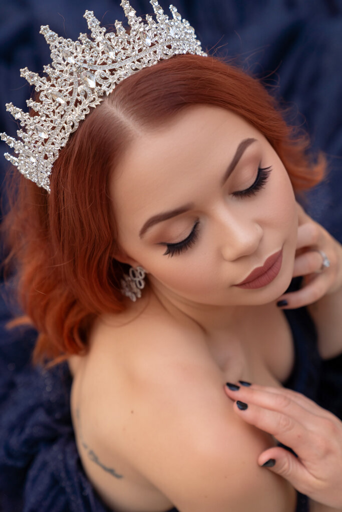 Artistic overhead portrait of redhead woman wearing crown soft ethereal photography