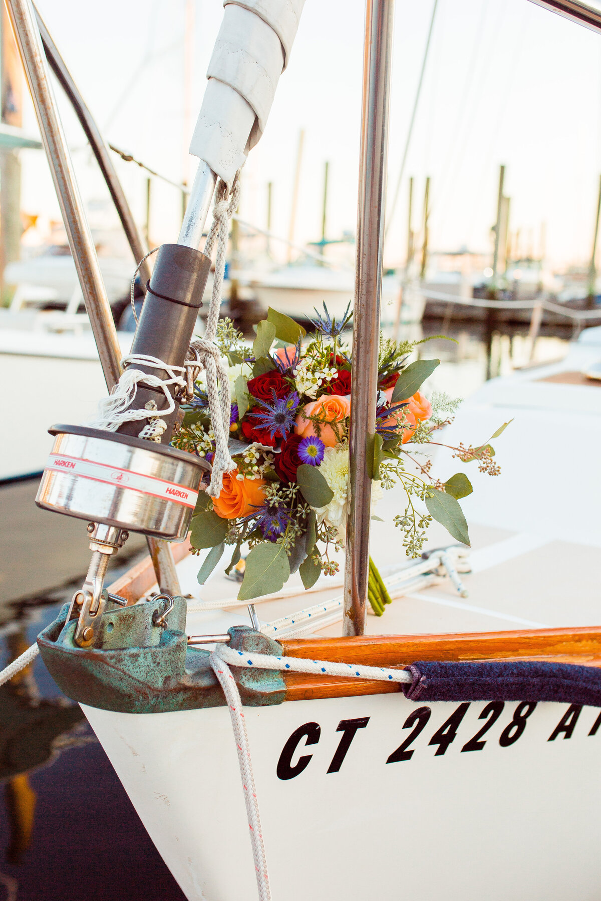 Wedding bouquet on the bow of a sailboat.