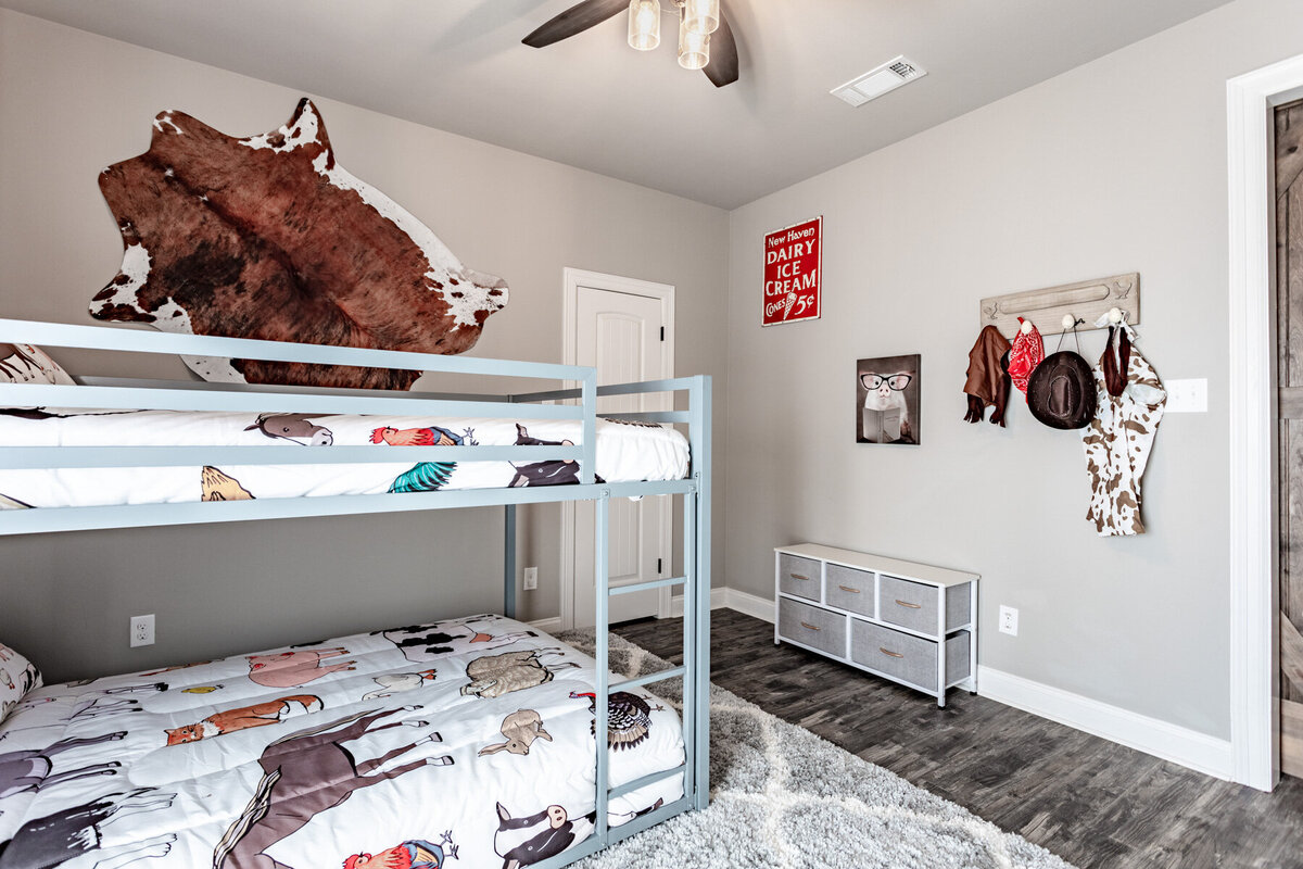 Bedroom with bunk beds perfect for kids in this five-bedroom, 3-bathroom vacation rental house for up to 10 guests with free wifi, private parking, outdoor games and seating, and bbq grill on 2 acres of land near Waco, TX.
