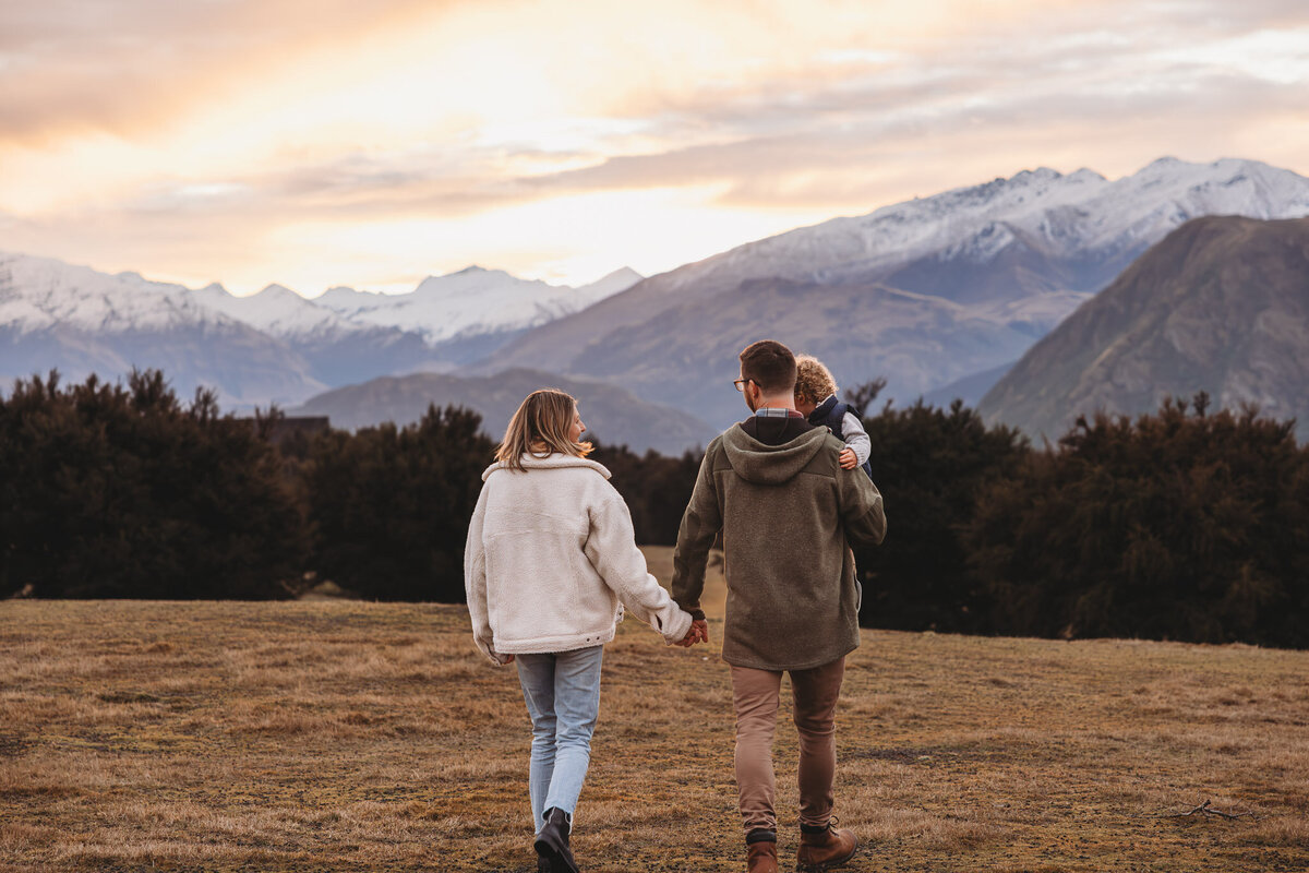 family walking in wanaka with snowy mountains in background during a wanaka family photoshoot captured by Bie
