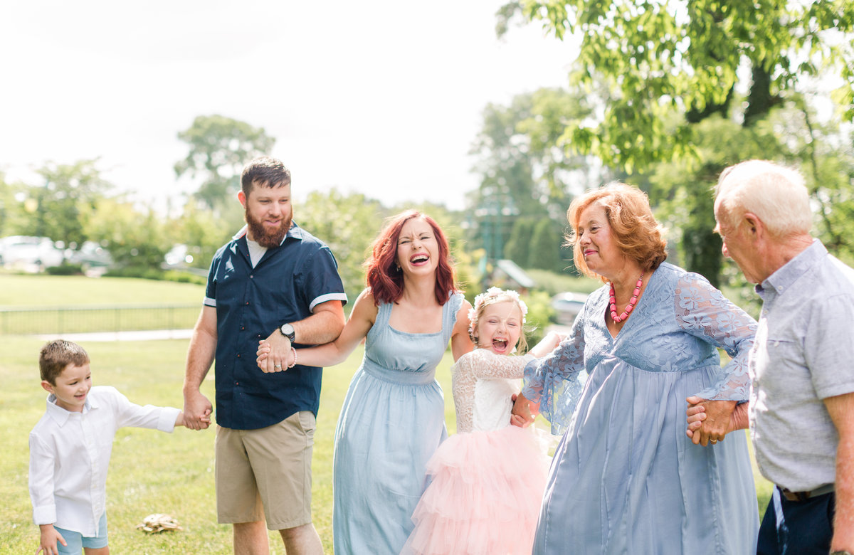 Joyful family laughing together during family portraits with Elizabeth Hill