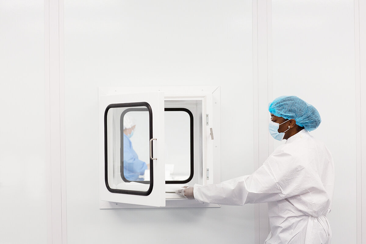 Woman placing item into a clean room passthrough