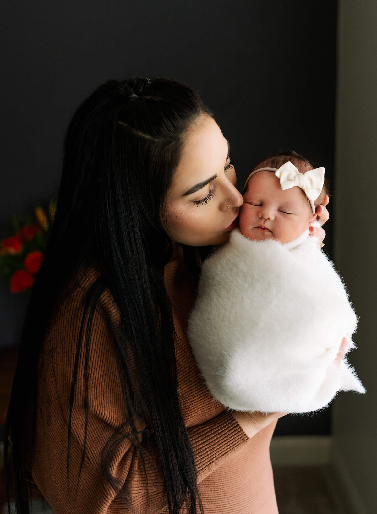 mother-holding-her-daughter-during-henderson-in-home-newborn-session