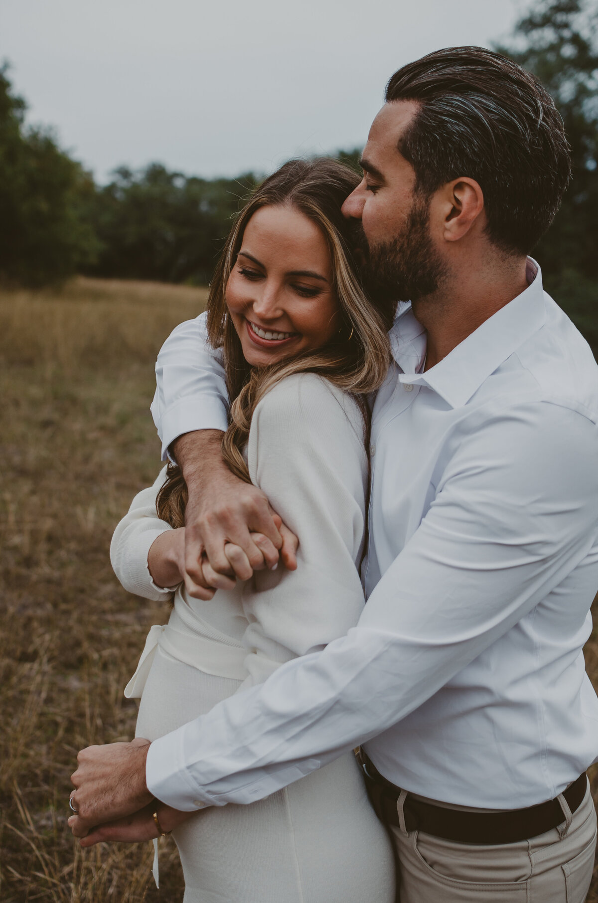 husband-and-wife-hugging-pregnant