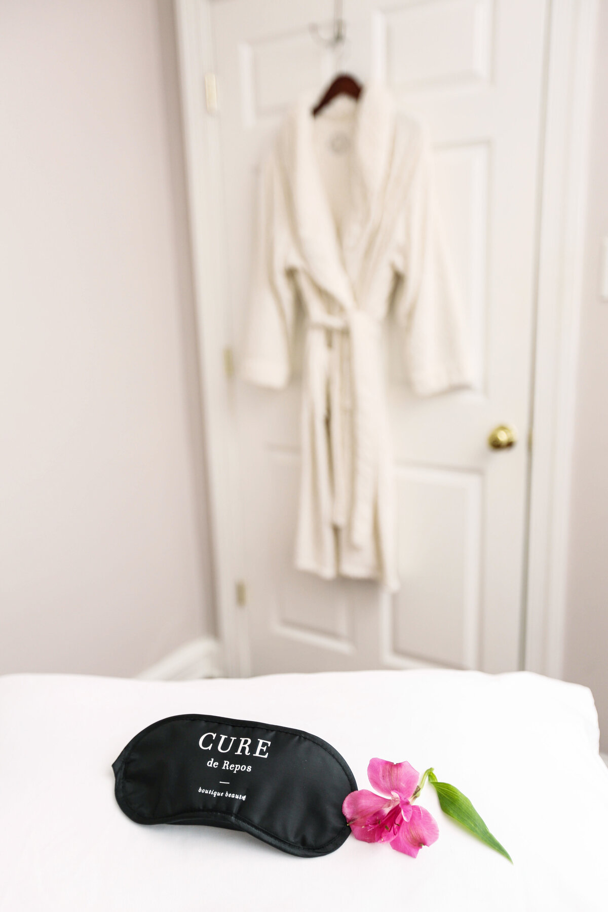 Eye mask for spa with bathrobe in the background