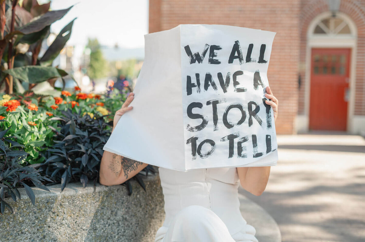 lit candle surrounded by printed photographs of women for brand photography photoshoot
