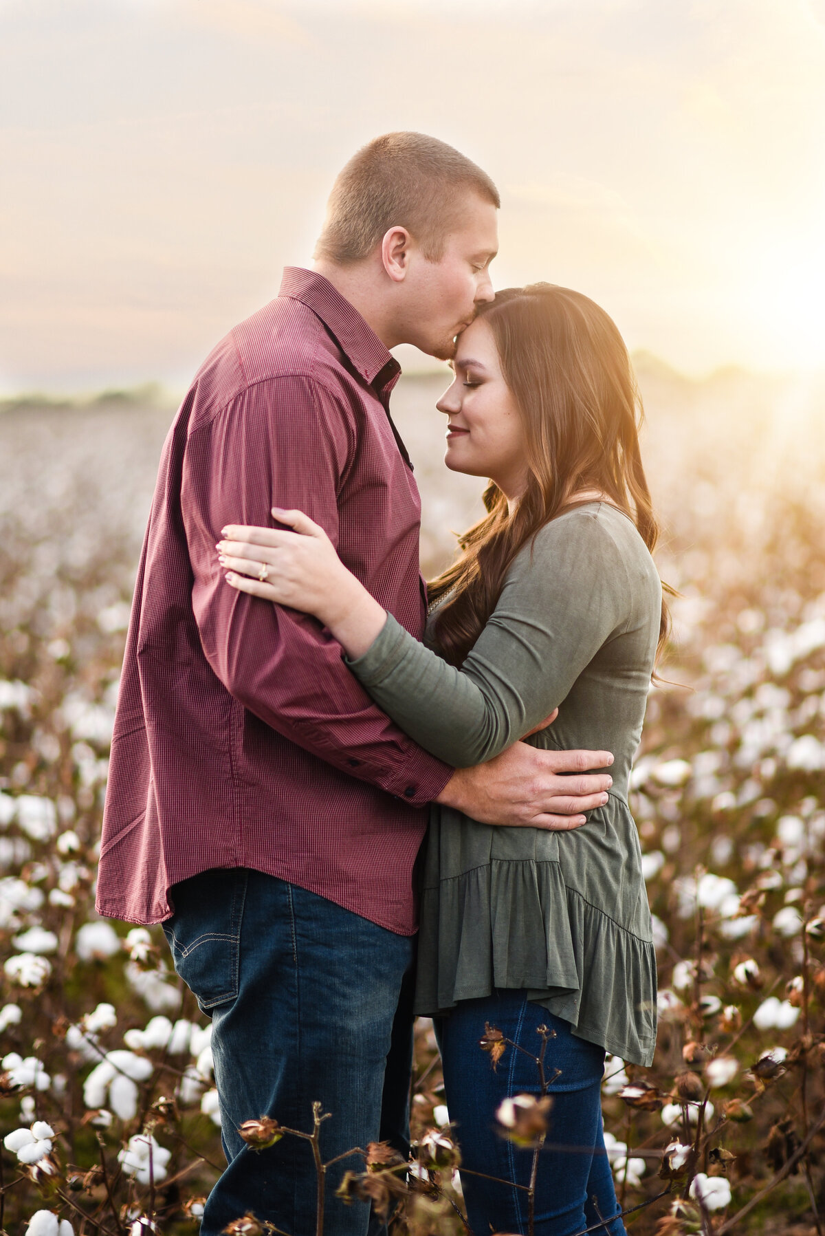 Beautiful Mississippi Engagement Photography: couple embraces at sunset in a cotton field, Southern Wedding Photography