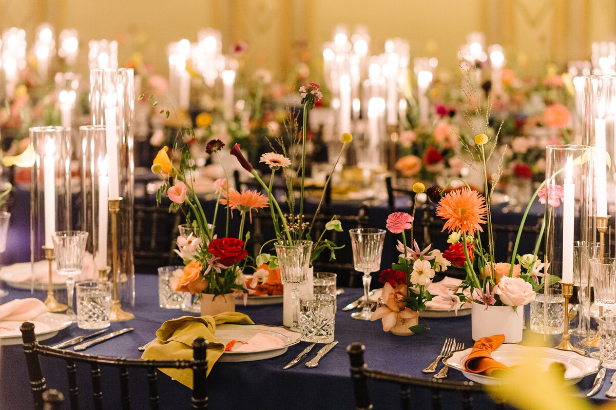 Colourful and eclectic decor with bright floral centrepieces at a wedding reception at Theatre Rialto.
