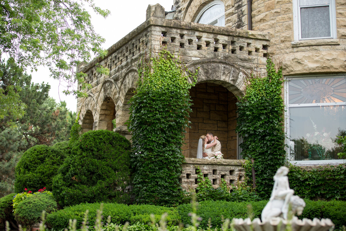 Classic bridal portrait at the arched entrance with beautiful landscape at the Haley Mansion