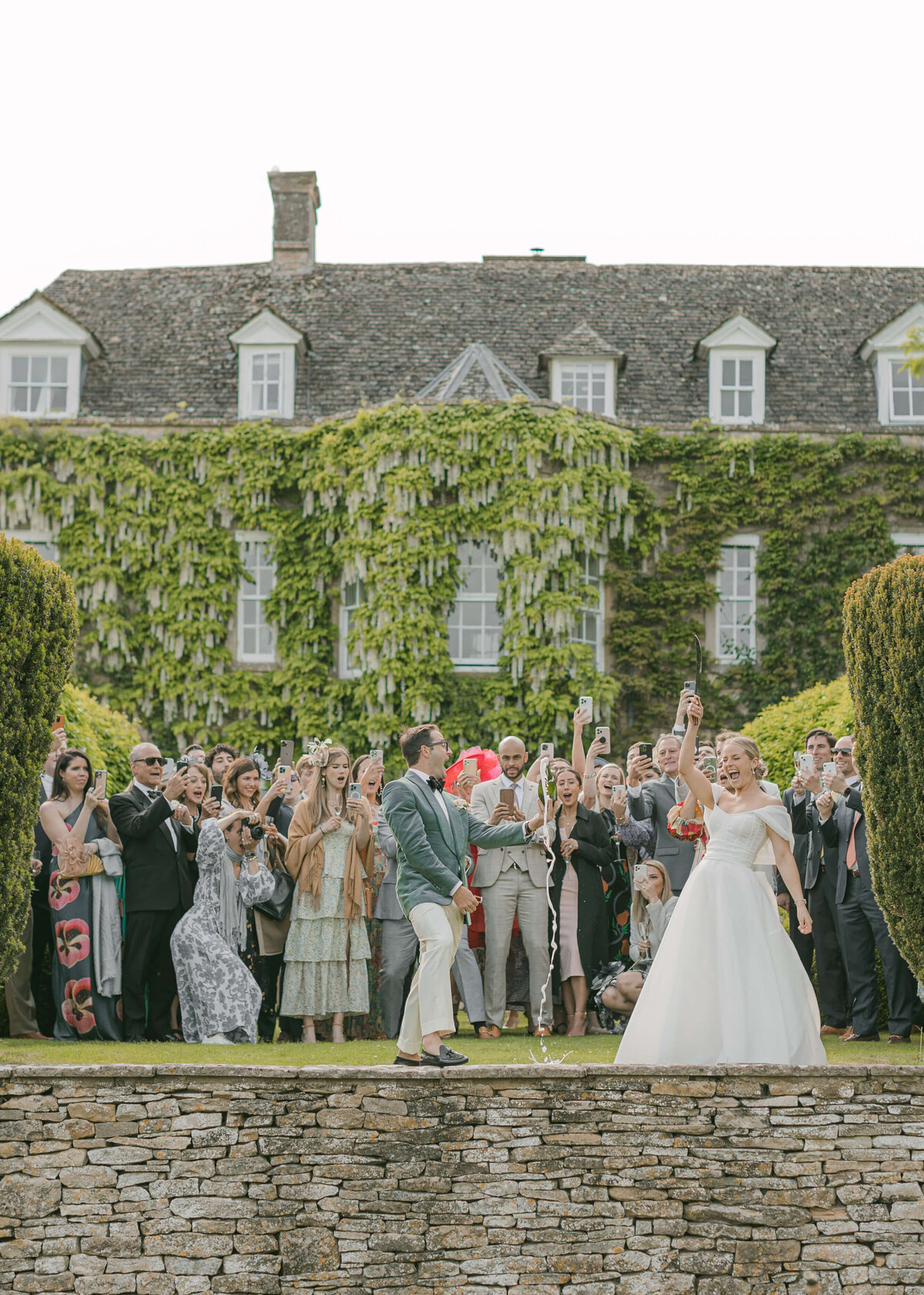 chloe-winstanley-weddings-cotswolds-cornwell-manor-champagne-sabre