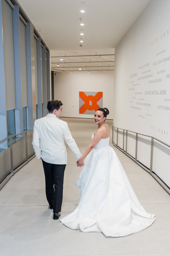 bride-and-groom-walking-through-museum-of-contemporary-arts-san-diego