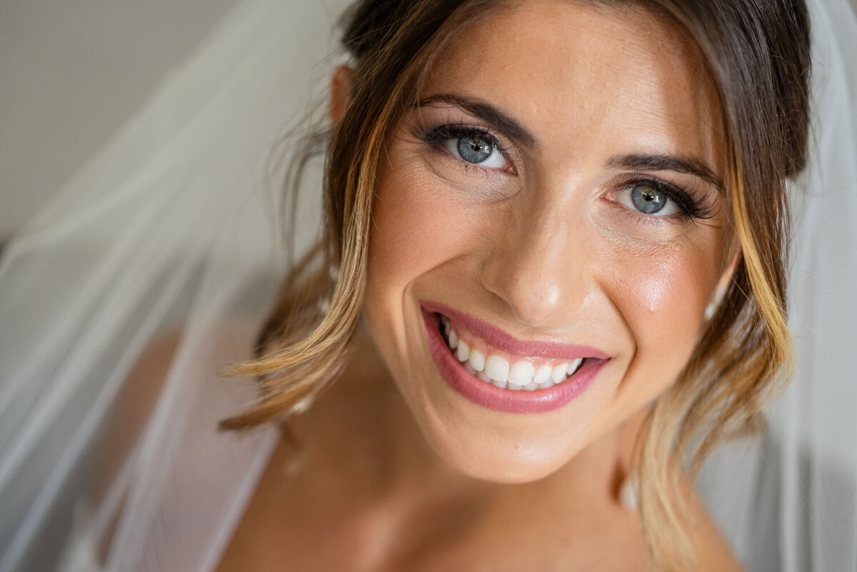 A close up of a woman 's face with a big smile
