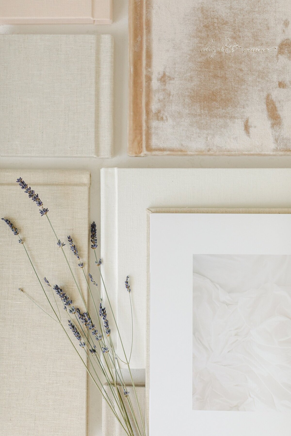 various cream and white linen & velvet heirloom albums available from Brittney Lear after taking your Indianapolis boudoir pictures.