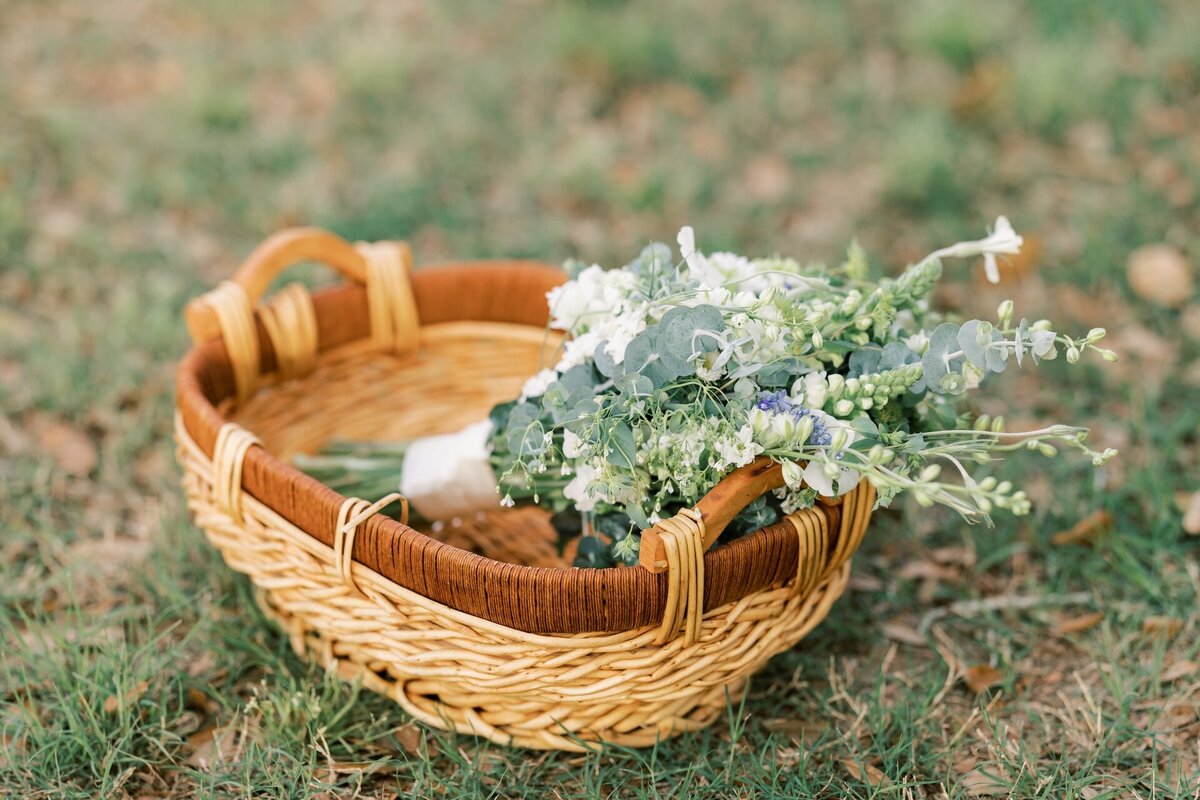 a wooden picnic basket filled with greenery