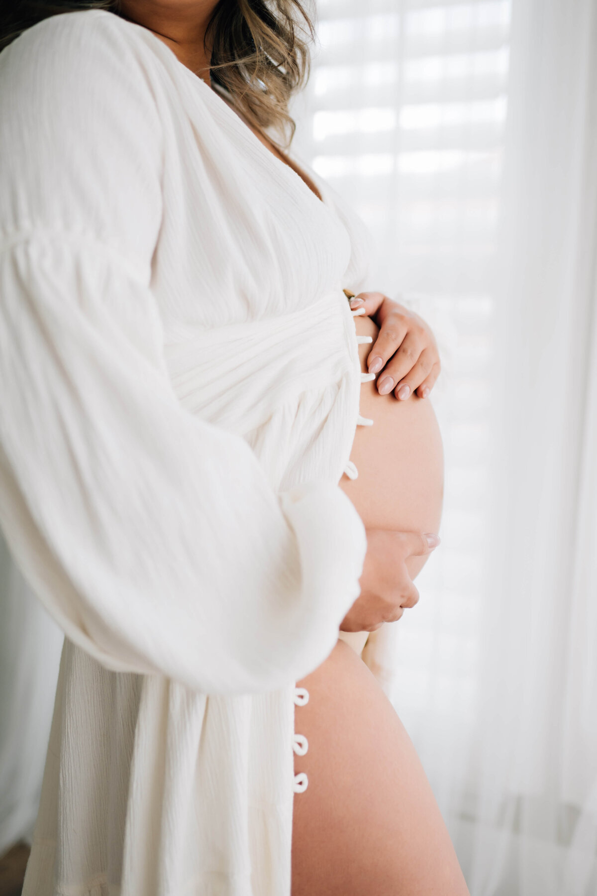 maternity woman holding her bare belly