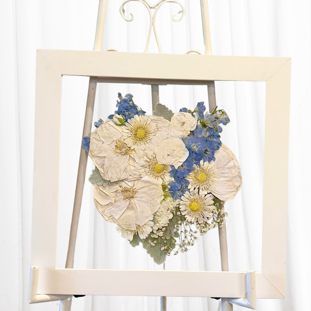 Wedding bouquet pressed in glass frame.