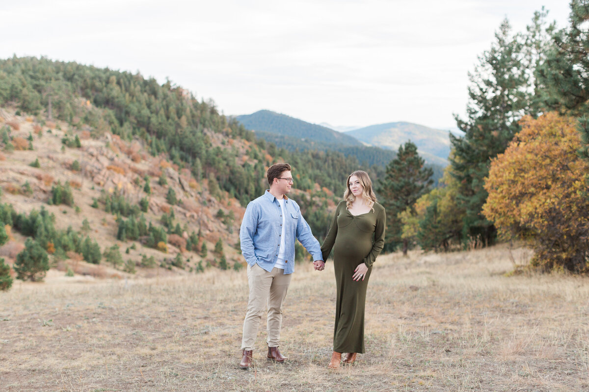A couple walking during their mountain maternity session