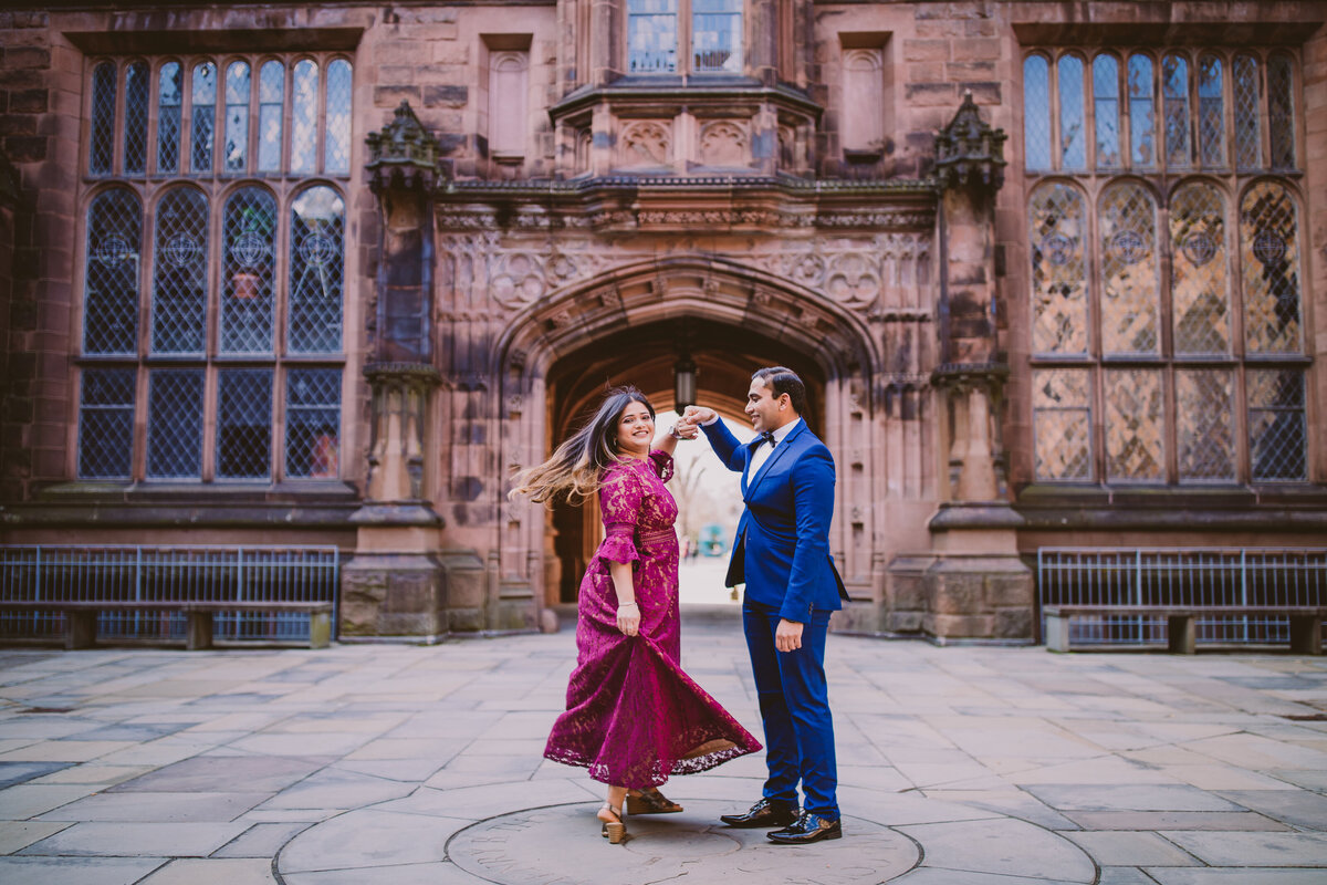 Groom twirling the bride inside the east pyne hall in princeton university in nj during their engagement session