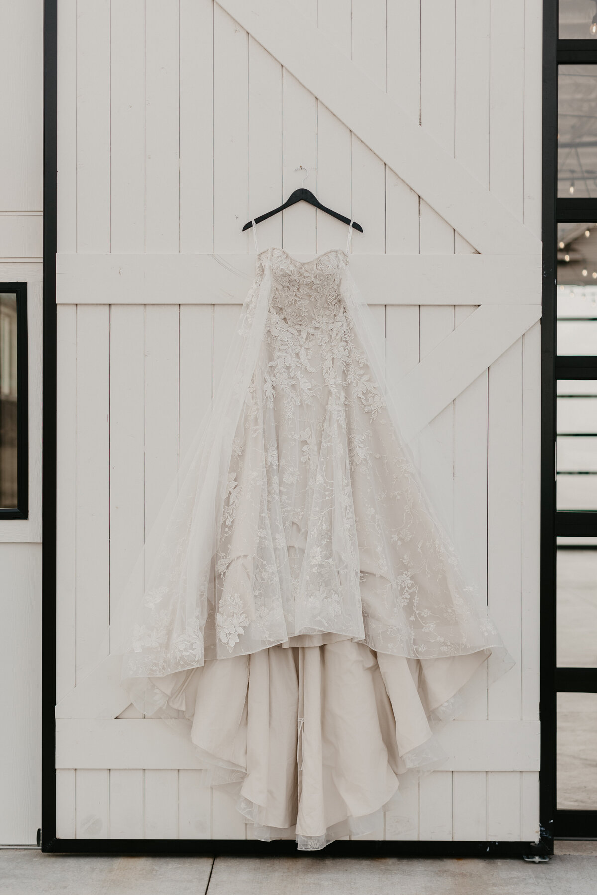 Wedding Dress Hanging on White Barn Door
