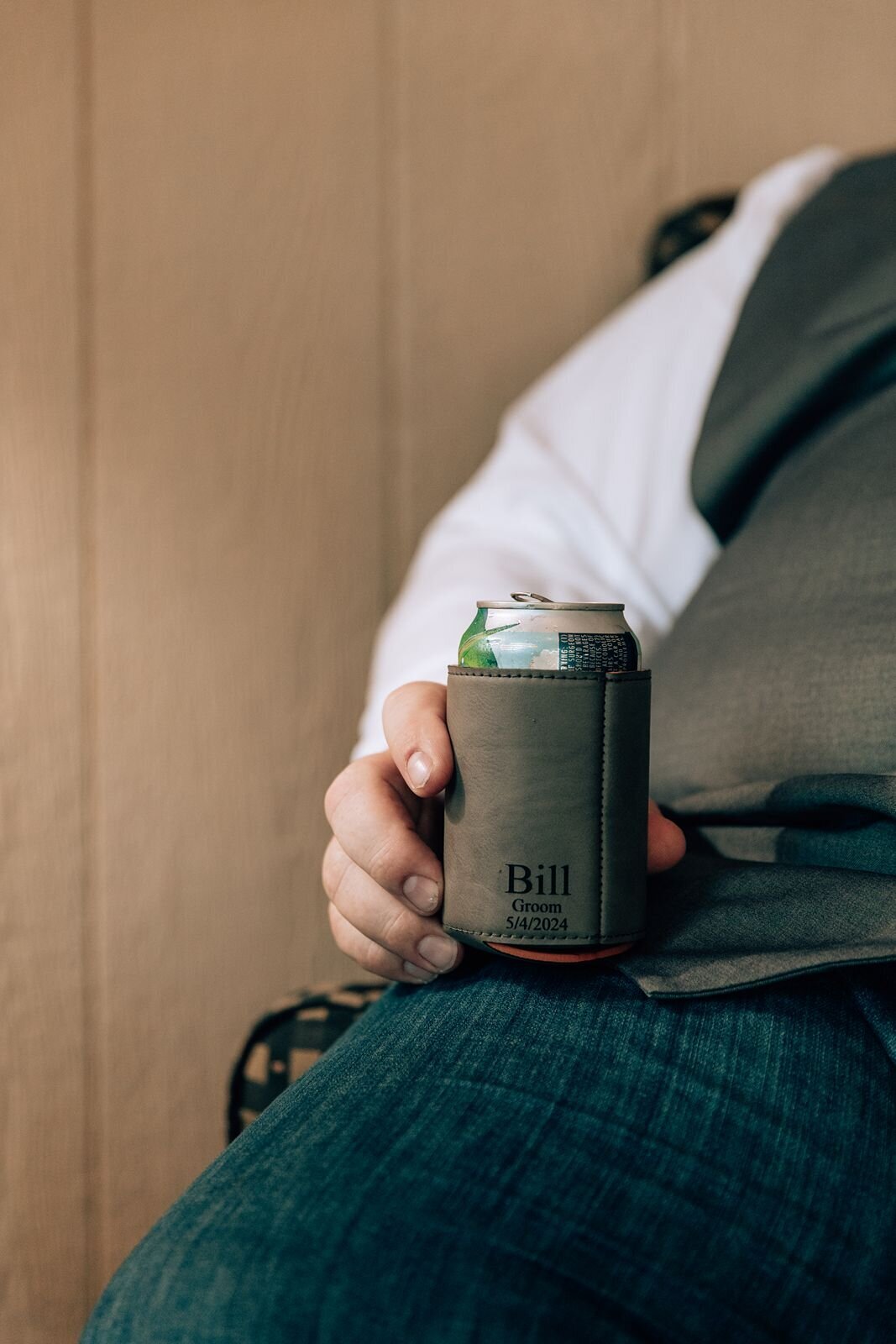 detail photo of the grooms coozie