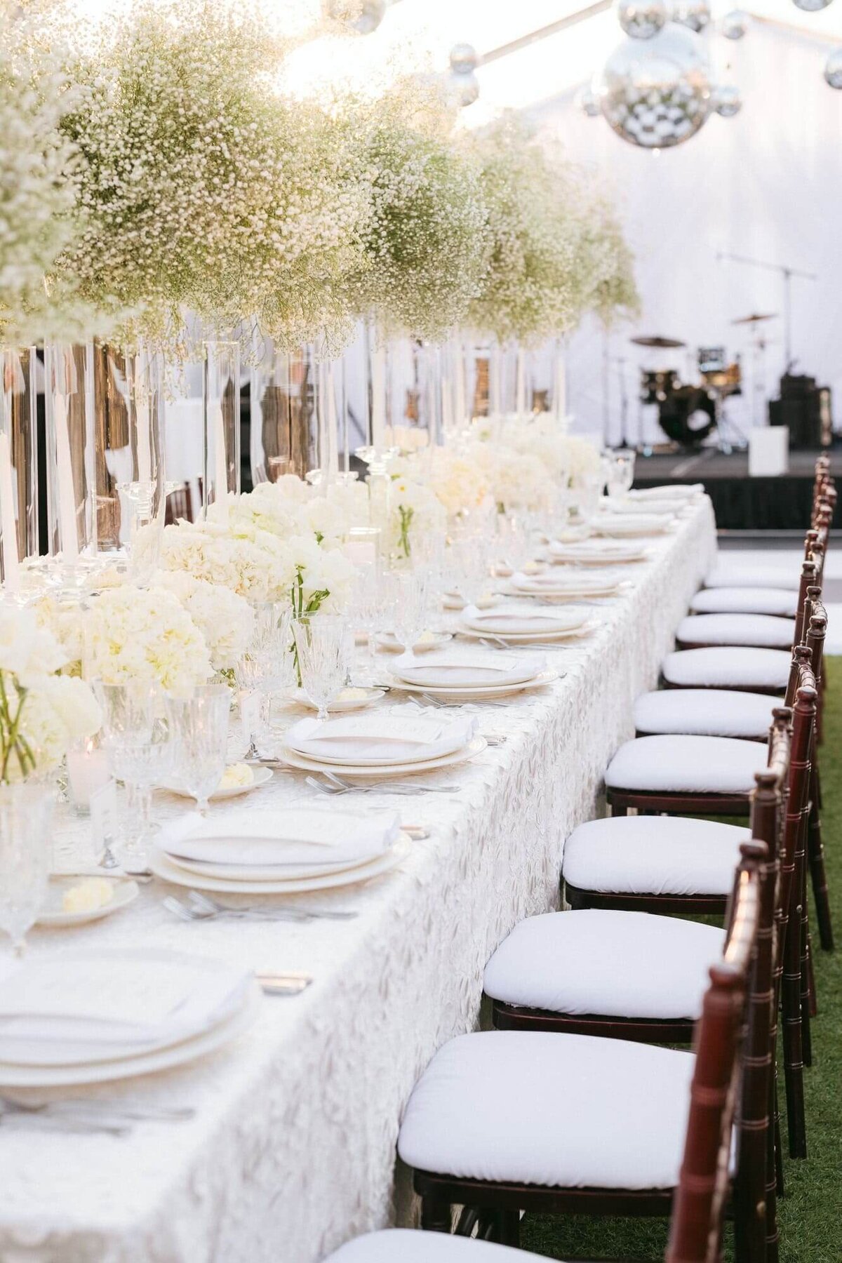 Elegant Arizona Biltmore wedding reception setup with long banquet table, white floral arrangements, and disco ball décor inside the wedding venue.