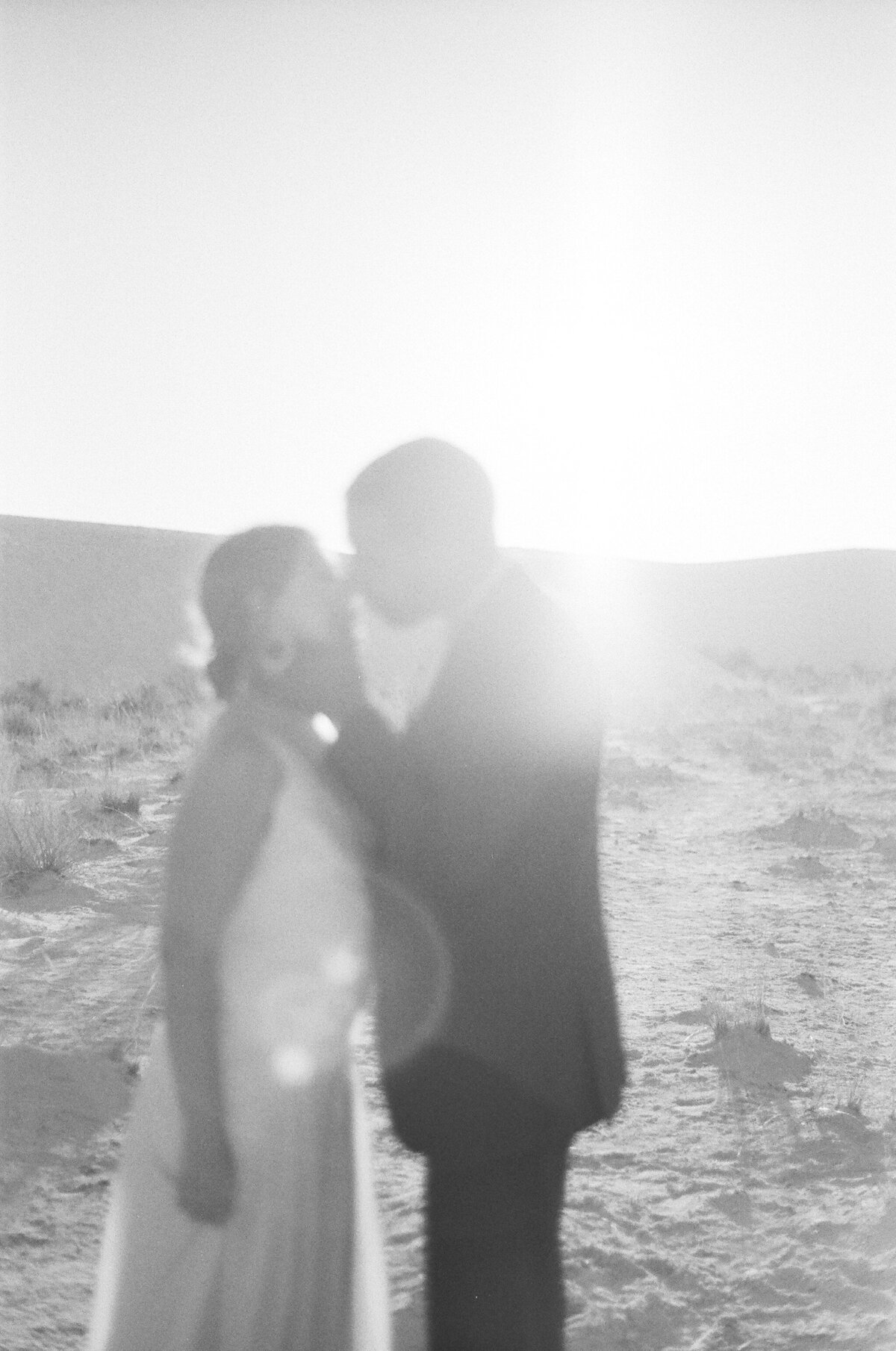 sunflare on a couple kissing white sands mexcio