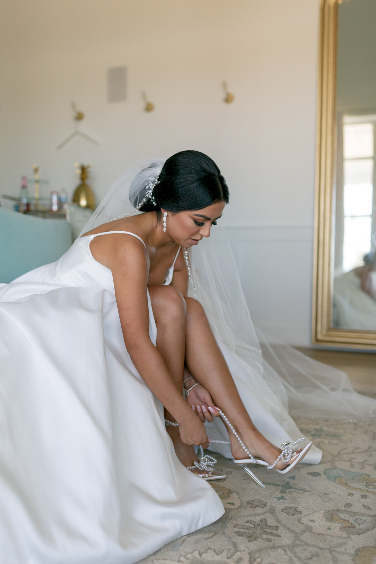bride putting on bridal shoes